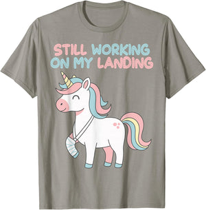 Still Working On My Landing Unicorn Funny Injury Broken T-Shirt - T-Shirt | Sand